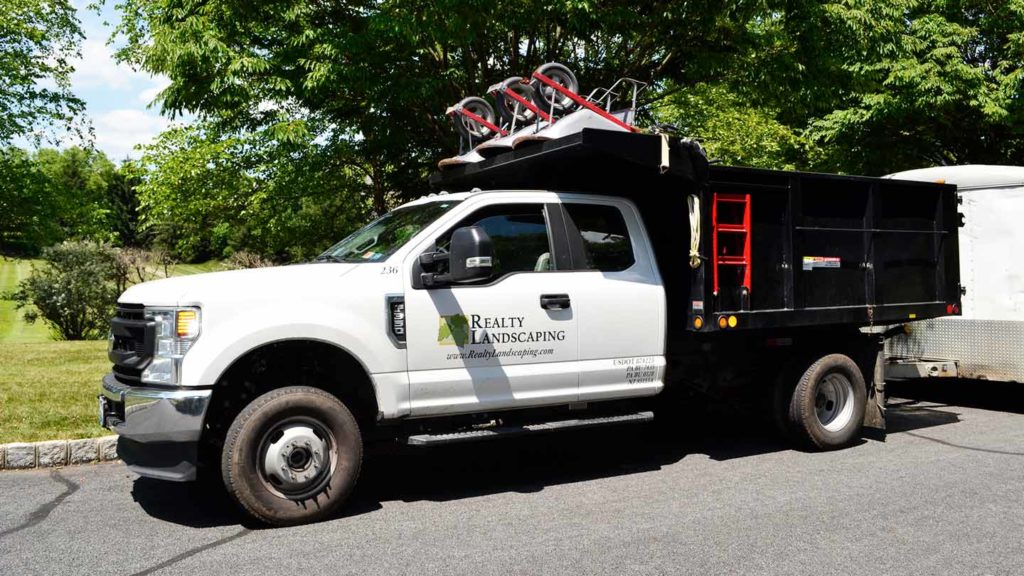 Realty Landscaping truck with wheel barrels on top